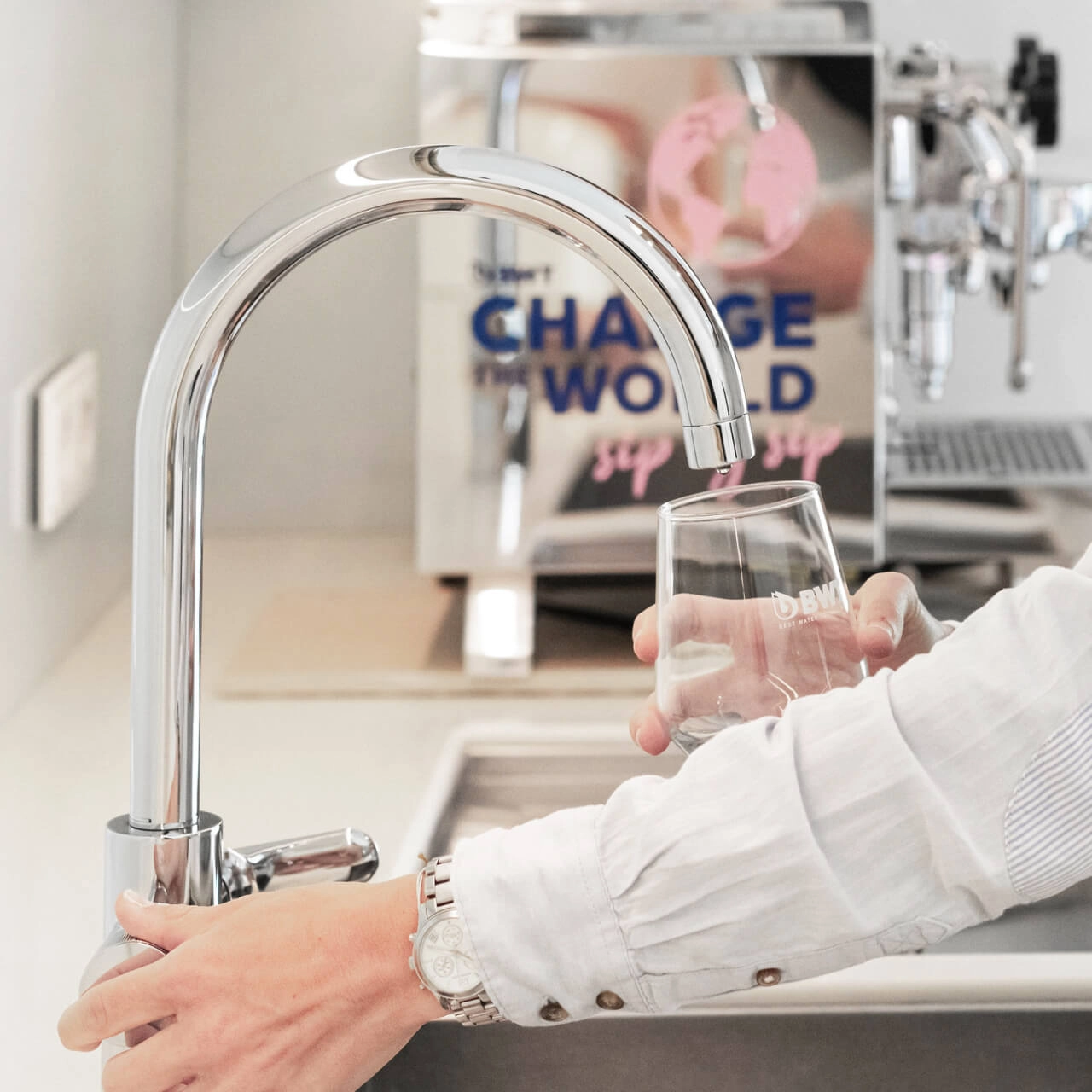 Woman fills glass at the tap