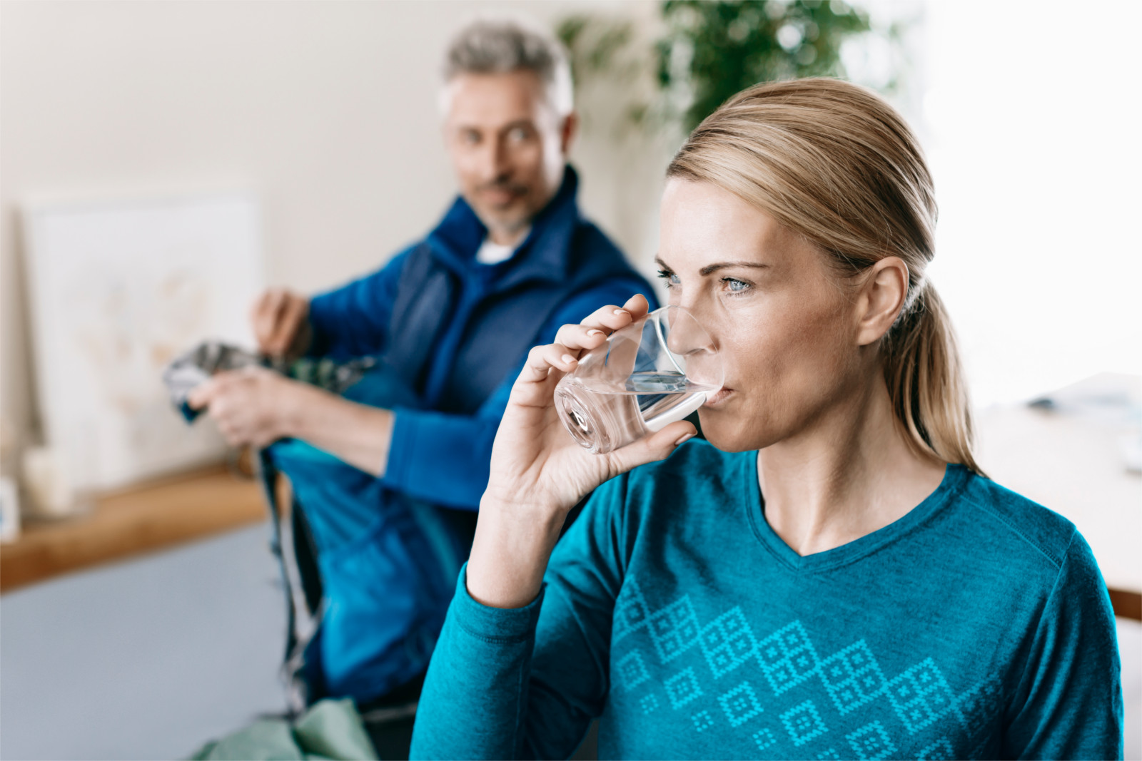 Lady drinks filtered water from Slim table water filter