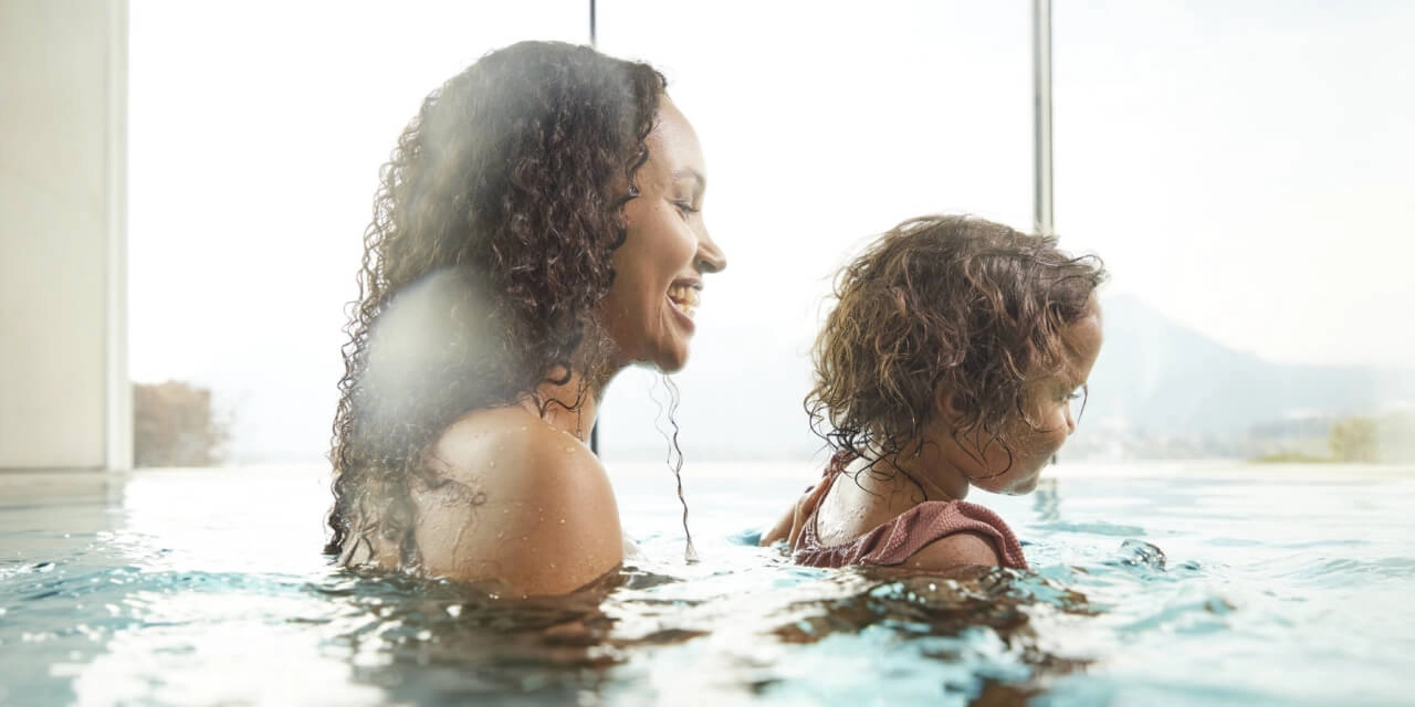 Woman with child in the pool